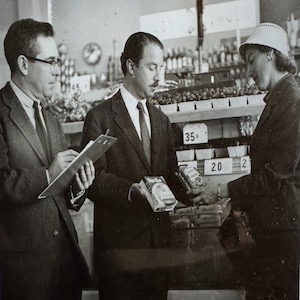 A group of officials talk with immigrants