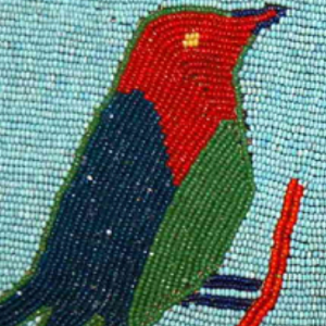 Image of a bird formed from blue, green, and red beads.