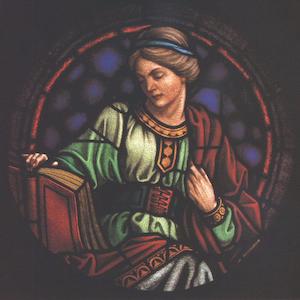 Image on stained glass of a woman reading a book