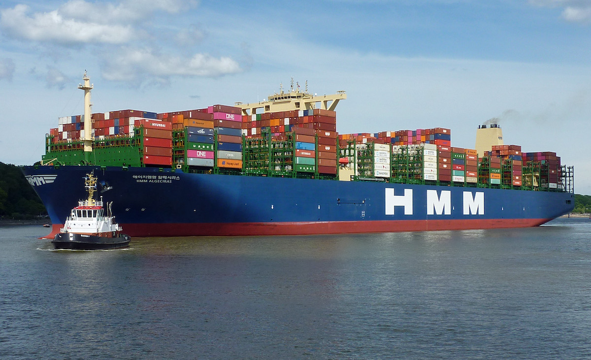 Photograph of a large ship loaded with shipping containers