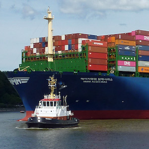 Photograph of a large ship loaded with shipping containers