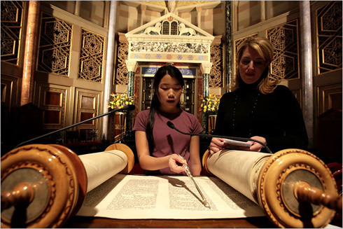 Photograph of girl reading from Torah
