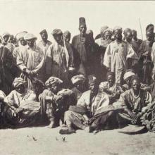 Photograph of a group of men posing. Description in annotation.